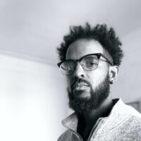 https://bricartsmedia.org/wp-content/uploads/2025/04/Adonis-Headshot-Pic-BW.jpg